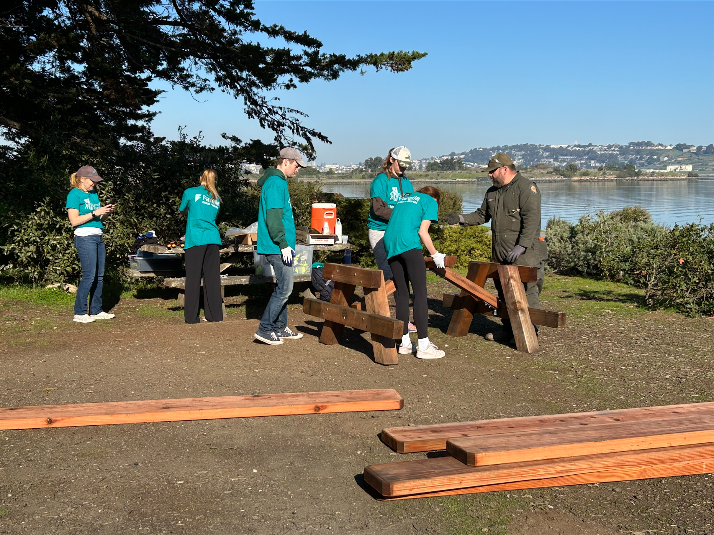 Group of people building a picnic table with Parks staff